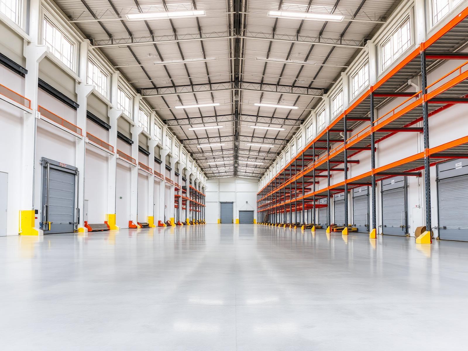 Warehouse interior with racking, polished concrete floor and dock doors